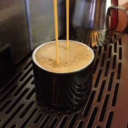 Photo of espresso pouring into a cup